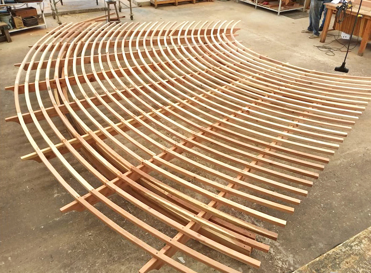 A fan-shaped pergola roof in construction at Forever Redwood’s woodworking shop.