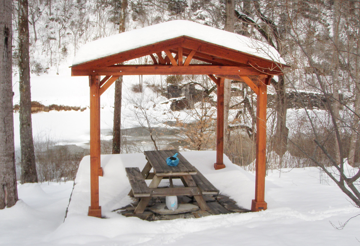 Del Norte Outdoor Kitchen Pavilion (Options: 12' L x 12' W, Mature Redwood, Unattached, 4-Post Anchor Kit for Stone, No Electrical Wiring Trim, 9' Posts, No Ceiling Fan Base, No Privacy Panels, No Curtain Rods, Transparent Premium Sealant). Photo Courtesy of Lisa K.  & Peter S. of Lexington, VA.