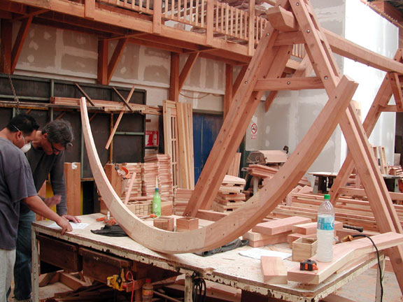 In this photo, our in-house master carpenter, Tony Toledo and I are working out ways of strengthening and refining the basic skeleton of an arched hammock stand design (the basic skeleton is next to us on the table).