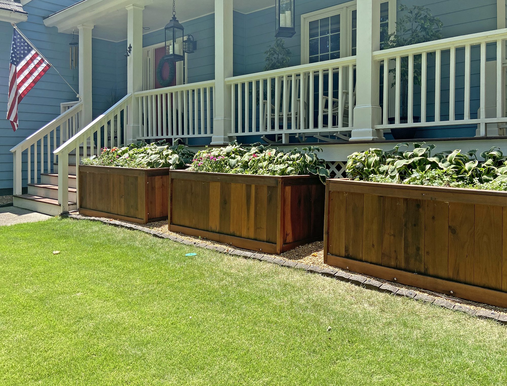 Row of redwood planters by a porch