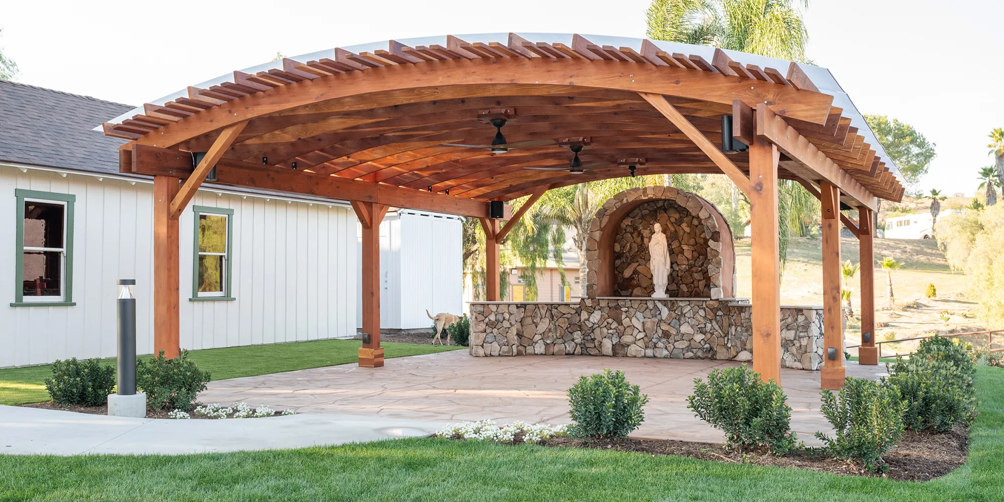 The Sebastopol Pergola, a curved redwood pergola over a stone grotto