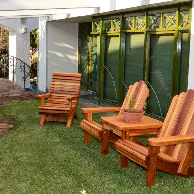 Adirondack Vignette Settee (Options: Standard Width, California Redwood, Rounded Corners, Umbrella Hole, Standard Seat Depth, No Cushion, No Ottoman, Transparent Premium Sealant) with an Ensenada Easychair. Photo Courtesy of El Estero Beach Resort of Ensenada, Baja.