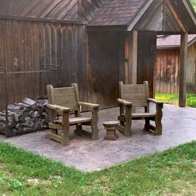 Angel's Armchair (Options: California Redwood, No Cushion, Transparent Premium Sealant). Photo Shows Chairs That Are 7 Years Old. Photo Also Shows a Mini 12 inch Round Wood Side Table. Photo Courtesy of Brenda Stafford of Vienna, Missouri.