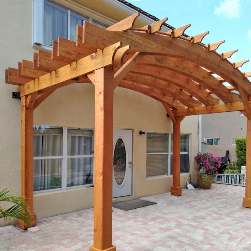 Custom Arched Open Sky Pergolas (Options: Douglas-fir, 10' H Posts, 4-Post Anchor Kit for Gale-Wind, Transparent Premium Sealant). Shows custom wall anchor customization to attach to home (can be added upon request). Custom Arched Open Sky Pergolas (Options: Douglas-fir, 10' H Posts, 4-Post Anchor Kit for Gale-Wind, Transparent Premium Sealant). Shows custom wall anchor customization to attach to home (can be added upon request).