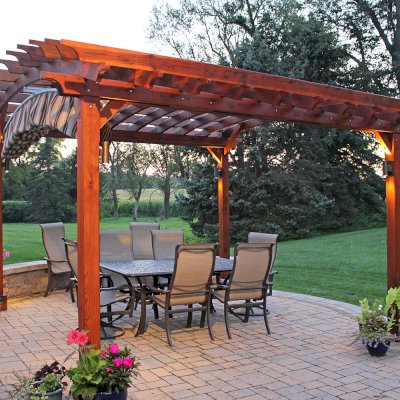 Arched Open Sky Pergolas (Options: 14' L x 14' Arc W, California Redwood, Unattached, Electrical Wiring Trim for 2 Posts, Arched Roof without Lattice Panels, 4-Post Anchor Kit for Concrete, No Ceiling Fan Base, No Privacy Panels, No Curtain Rods, 9' Post Height, Transparent Premium Sealant). 18" Overhang of Arches. Ends of arches with Same Roosevelt End Detail Work as Have the Supports and Slats. Pergola Installed in 2014. Photo Courtesy of J. Martin of Morgantown, Pennsylvania.