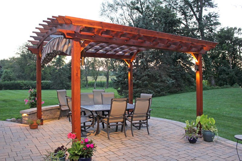 Arched Open Sky Pergolas (Options: 14' L x 14' Arc W, California Redwood, Unattached, Electrical Wiring Trim for 2 Posts, Arched Roof without Lattice Panels, 4 Post Anchor Kit for Concrete, No Ceiling Fan Base, No Privacy Panels, No Curtain Rods, 9' Post Height, Transparent Premium Sealant). 18" Overhang of Arches. Ends of arches with Same Roosevelt End Detail Work as Have the Supports and Slats. Pergola Installed in 2014. Photo Courtesy of J. Martin of Morgantown, Pennsylvania. Arched Open Sky Pergolas (Options: 14' L x 14' Arc W, California Redwood, Unattached, Electrical Wiring Trim for 2 Posts, Arched Roof without Lattice Panels, 4 Post Anchor Kit for Concrete, No Ceiling Fan Base, No Privacy Panels, No Curtain Rods, 9' Post Height, Transparent Premium Sealant). 18" Overhang of Arches. Ends of arches with Same Roosevelt End Detail Work as Have the Supports and Slats. Pergola Installed in 2014. Photo Courtesy of J. Martin of Morgantown, Pennsylvania.