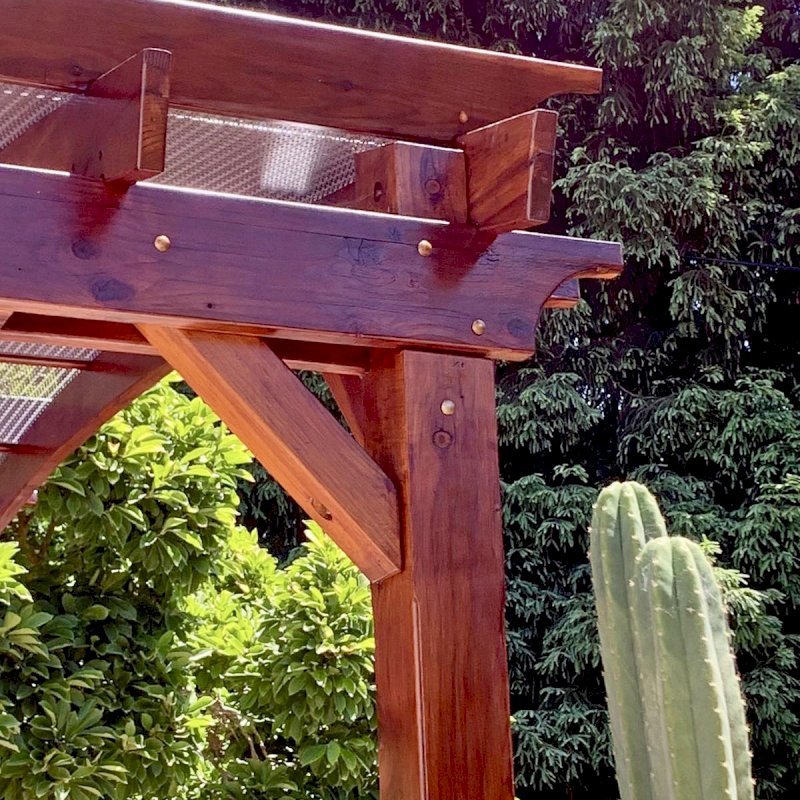 Arched Open Sky Pergolas (Options: 12' L x 14' Arc W, California Redwood, 1 Electrical Wiring Trim, 4 Post Anchor Kit for Concrete, No Ceiling Fan Base, No Privacy Panels, No Curtain Rods, 9.5' Post Height, Transparent Premium Sealant). Custom decorative steel shading added by customer. Photo was taken one year after installation. Photo Courtesy of K. Cates of Oajland, California. Arched Open Sky Pergolas (Options: 12' L x 14' Arc W, California Redwood, 1 Electrical Wiring Trim, 4 Post Anchor Kit for Concrete, No Ceiling Fan Base, No Privacy Panels, No Curtain Rods, 9.5' Post Height, Transparent Premium Sealant). Custom decorative steel shading added by customer. Photo was taken one year after installation. Photo Courtesy of K. Cates of Oajland, California.
