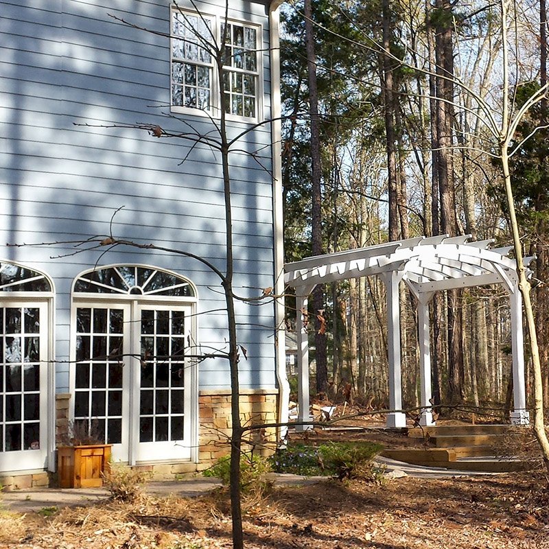Arched Open Sky Pergolas (Options: 10' L x 12' Arc W, Douglas-fir, Unattached, No Electrical Wiring Trim, Arched Roof without Lattice Panels, 4 Post Anchor Kit for Stone, No Ceiling Fan Base, No Privacy Panels, No Curtain Rods, 9' Post Height, Off-White Oil-Based Primer). Photo courtesy of D. Bochnovic of Henderson, North Carolina. Arched Open Sky Pergolas (Options: 10' L x 12' Arc W, Douglas-fir, Unattached, No Electrical Wiring Trim, Arched Roof without Lattice Panels, 4 Post Anchor Kit for Stone, No Ceiling Fan Base, No Privacy Panels, No Curtain Rods, 9' Post Height, Off-White Oil-Based Primer). Photo courtesy of D. Bochnovic of Henderson, North Carolina.