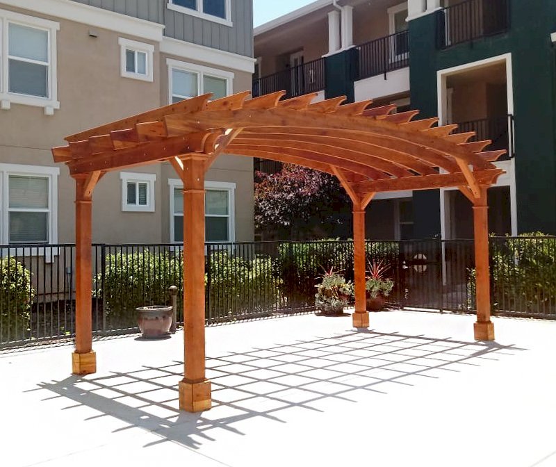 Arched Open Sky Pergolas (Options: 10' L x 20' Arc W, California Redwood, No Electrical Wiring Trim, Horizontal Decorative Trims on Posts, 4 Post Anchor Kit for Concrete, No Ceiling Fan Base, No Privacy Panels, No Curtain Rods, 9' Post Height, Transparent Premium Sealant). Photo Courtesy of M. Castaneda of Pleasanton, CA. Arched Open Sky Pergolas (Options: 10' L x 20' Arc W, California Redwood, No Electrical Wiring Trim, Horizontal Decorative Trims on Posts, 4 Post Anchor Kit for Concrete, No Ceiling Fan Base, No Privacy Panels, No Curtain Rods, 9' Post Height, Transparent Premium Sealant). Photo Courtesy of M. Castaneda of Pleasanton, CA.
