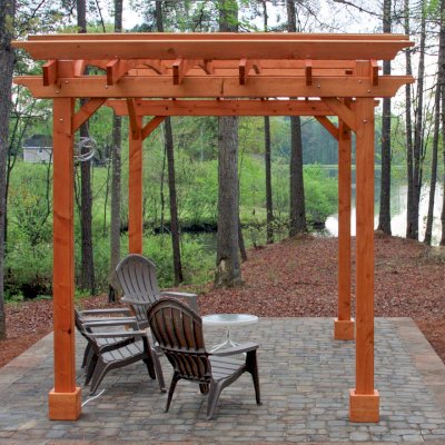 Arched Open Sky Pergolas (Options: 10' L x 14' Arc W, Mature Redwood, Unattached, No Electrical Wiring Trim, Arched Roof without Lattice Panels, 4-Post Anchor Kit for Stone, With Ceiling Fan Base, No Privacy Panels, No Curtain Rods, 9' Post Height, Transparent Premium Sealant). Photo Courtesy of Randall & Florence W. of Willow Spring, North Carolina.