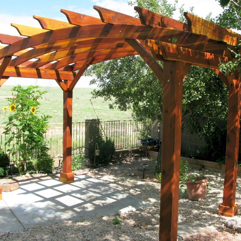Arched Open Sky Pergolas (Custom Options: 8' L x 14' Arc W, California Redwood, Unattached, No Electrical Wiring Trim, Arched Roof without Lattice Panels, 4 Post Anchor kit for Stone, No Ceiling Fan Base, No Privacy Panels, No Curtain Rods, 10' Post Height, Transparent Premium Sealant). Photo Courtesy of Pat P. of Prescott Valley, Arizona. Arched Open Sky Pergolas (Custom Options: 8' L x 14' Arc W, California Redwood, Unattached, No Electrical Wiring Trim, Arched Roof without Lattice Panels, 4 Post Anchor kit for Stone, No Ceiling Fan Base, No Privacy Panels, No Curtain Rods, 10' Post Height, Transparent Premium Sealant). Photo Courtesy of Pat P. of Prescott Valley, Arizona.