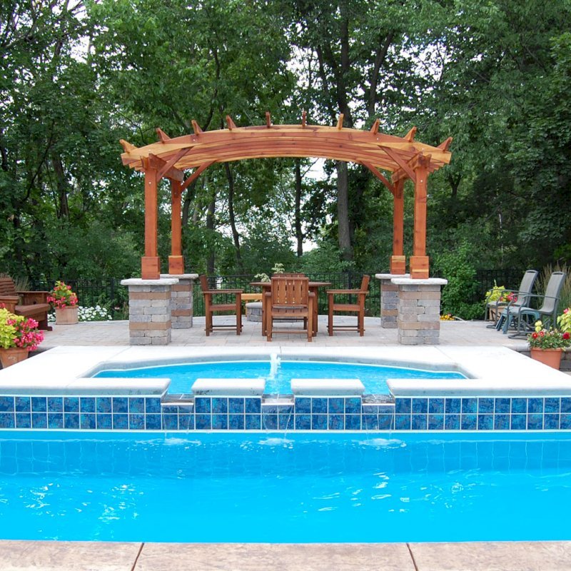 Arched Open Sky Pergolas (Options: 10' L x 14' Arc W, California Redwood, Unattached, No Electrical Wiring Trim, Arched Roof Without Lattice Panels, 4 Post Anchor Kit for Stone, No Ceiling Fan Base, No Privacy Panels, No Curtain Rods, Custom Post Height, Transparent Premium Sealant). Photo Courtesy of Glen Vick of Lafayette, IN. Table set under Pergola not built by Forever Redwood. Arched Open Sky Pergolas (Options: 10' L x 14' Arc W, California Redwood, Unattached, No Electrical Wiring Trim, Arched Roof Without Lattice Panels, 4 Post Anchor Kit for Stone, No Ceiling Fan Base, No Privacy Panels, No Curtain Rods, Custom Post Height, Transparent Premium Sealant). Photo Courtesy of Glen Vick of Lafayette, IN. Table set under Pergola not built by Forever Redwood.