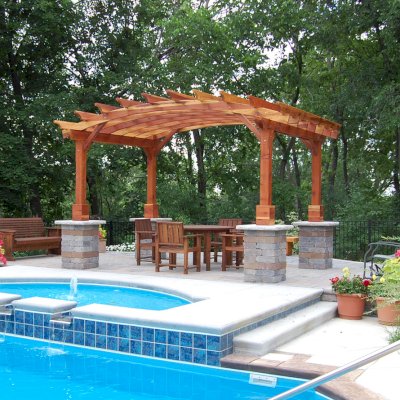 Arched Open Sky Pergolas (Options: 10' L x 14' Arc W, California Redwood, Unattached, No Electrical Wiring Trim, Arched Roof Without Lattice Panels, 4-Post Anchor Kit for Stone, No Ceiling Fan Base, No Privacy Panels, No Curtain Rods, Custom Post Height, Transparent Premium Sealant). Photo Courtesy of Glen Vick of Lafayette, IN. Table set under Pergola not built by Forever Redwood.