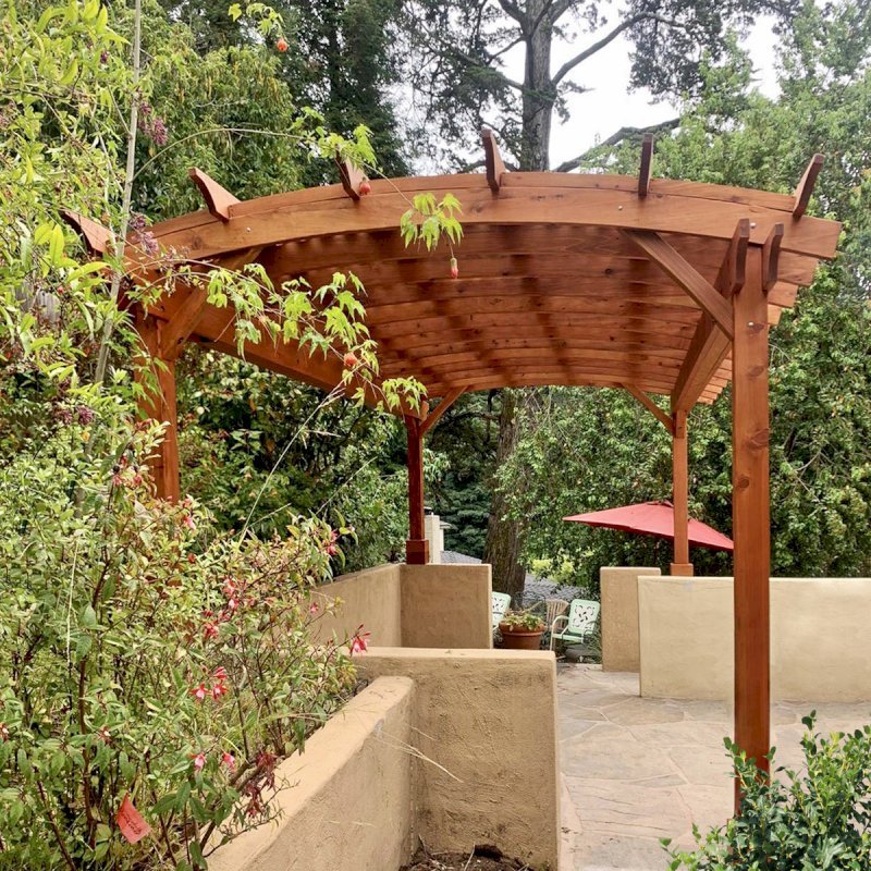 Arched Pergola Kit (Options: 20' L x 12' Arc W, Mature Redwood, No Electrical Wiring Trim Kits, 4 Post Anchor Kit for Concrete, No Ceiling Fan Bases, No Privacy Panels, No Curtain Rods, 9.5' Post Height, Transparent Premium Sealant). Photo Courtesy of L. Nelson of Oakland, CA. Arched Pergola Kit (Options: 20' L x 12' Arc W, Mature Redwood, No Electrical Wiring Trim Kits, 4 Post Anchor Kit for Concrete, No Ceiling Fan Bases, No Privacy Panels, No Curtain Rods, 9.5' Post Height, Transparent Premium Sealant). Photo Courtesy of L. Nelson of Oakland, CA.
