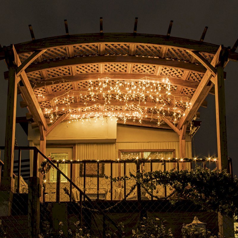 Arched Pergola Kit (Options: 12' L x 16' Arc W, Mosaic Eco-Wood, No Electrical Wiring Trim Kit, 4 Post Anchor Kit for Wood, No Ceiling Fan Bases, No Privacy Panels, No Curtain Rods, 9' Post Height, Transparent Premium Sealant). Free Standing Pergola was altered slightly to place up against house by limiting overhang on house side. Arched Pergola Kit (Options: 12' L x 16' Arc W, Mosaic Eco-Wood, No Electrical Wiring Trim Kit, 4 Post Anchor Kit for Wood, No Ceiling Fan Bases, No Privacy Panels, No Curtain Rods, 9' Post Height, Transparent Premium Sealant). Free Standing Pergola was altered slightly to place up against house by limiting overhang on house side.