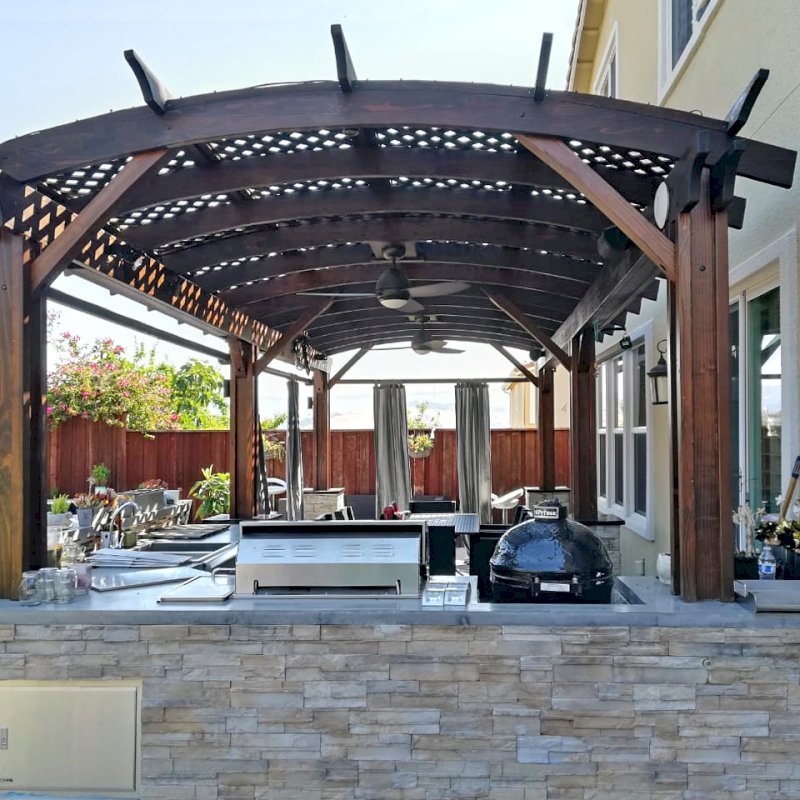 Arched Pergola Kit (Options: 26' L x 12' Arc W, California Redwood, 2 Electrical Wiring Trims, Vertical Post Decorative Trims, 2 Fan Bases, 2 Curtain Rods, No Privacy Panels, Coffee-Stain Premium Sealant). Photo Courtesy of D. Jackson of San Jose, California. Arched Pergola Kit (Options: 26' L x 12' Arc W, California Redwood, 2 Electrical Wiring Trims, Vertical Post Decorative Trims, 2 Fan Bases, 2 Curtain Rods, No Privacy Panels, Coffee-Stain Premium Sealant). Photo Courtesy of D. Jackson of San Jose, California.
