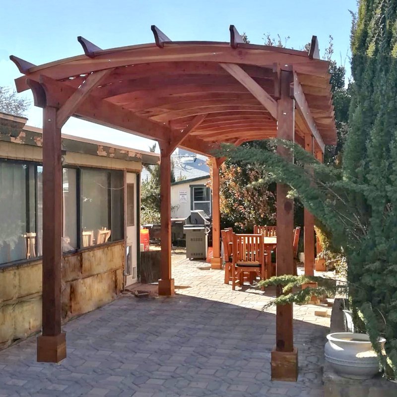 Arched Pergola Kit (Options: 30' L x 10' Arc W, California Redwood, 2 Electrical Wiring Trim Kits, 6 Post Anchor Kit for Concrete, No Ceiling Fan Bases, No Privacy Panels, No Curtain Rods, 9' Post Height, Transparent Premium Sealant). Photo Courtesy of J. Wangemann of Ridgecrest, CA. Arched Pergola Kit (Options: 30' L x 10' Arc W, California Redwood, 2 Electrical Wiring Trim Kits, 6 Post Anchor Kit for Concrete, No Ceiling Fan Bases, No Privacy Panels, No Curtain Rods, 9' Post Height, Transparent Premium Sealant). Photo Courtesy of J. Wangemann of Ridgecrest, CA.