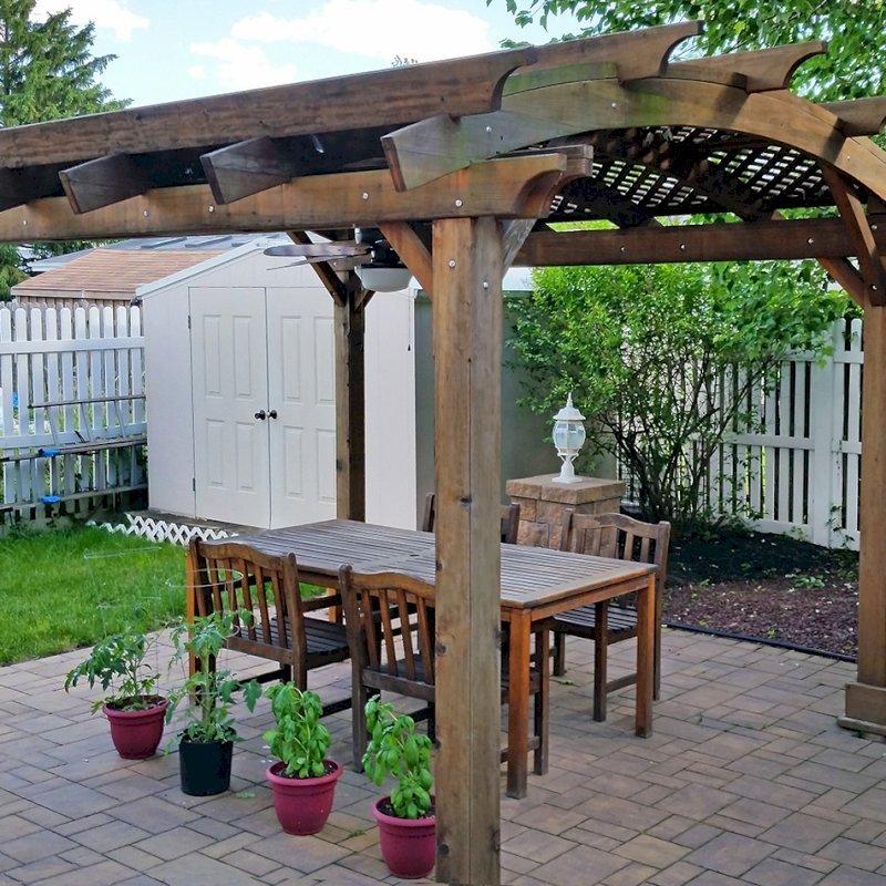 Arched Pergola Kit (Options: 14' L x 12' Arc W, California Redwood, No Electrical Wiring Trim Kit, 4 Post Anchor Kit for Concrete, No Ceiling Fan Base, No Privacy Panels, No Curtain Rods, 9' Post Height, Transparent Premium Sealant). Photo Courtesy of Joe Cario of Moonachie, New Jersey. Arched Pergola Kit (Options: 14' L x 12' Arc W, California Redwood, No Electrical Wiring Trim Kit, 4 Post Anchor Kit for Concrete, No Ceiling Fan Base, No Privacy Panels, No Curtain Rods, 9' Post Height, Transparent Premium Sealant). Photo Courtesy of Joe Cario of Moonachie, New Jersey.