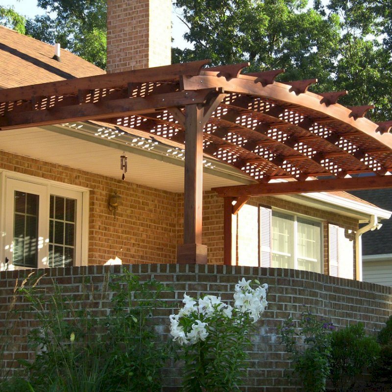 Arched Pergola Kits (Options: 10' L x 22' Arc W, Mature Redwood, Unattached, No Electrical Wiring Trim, Arched Roof with Lattice Panels, 4 Post Anchor kit for Stone, No Ceiling Fan Base, No Privacy Panels, No Curtain Rods, 9' Post Height (Front Posts Shorter by Custom Request), Cherry Stain Premium Sealant). Photo Courtesy of Josef M. of Fayetteville, Pennsylvania. Arched Pergola Kits (Options: 10' L x 22' Arc W, Mature Redwood, Unattached, No Electrical Wiring Trim, Arched Roof with Lattice Panels, 4 Post Anchor kit for Stone, No Ceiling Fan Base, No Privacy Panels, No Curtain Rods, 9' Post Height (Front Posts Shorter by Custom Request), Cherry Stain Premium Sealant). Photo Courtesy of Josef M. of Fayetteville, Pennsylvania.