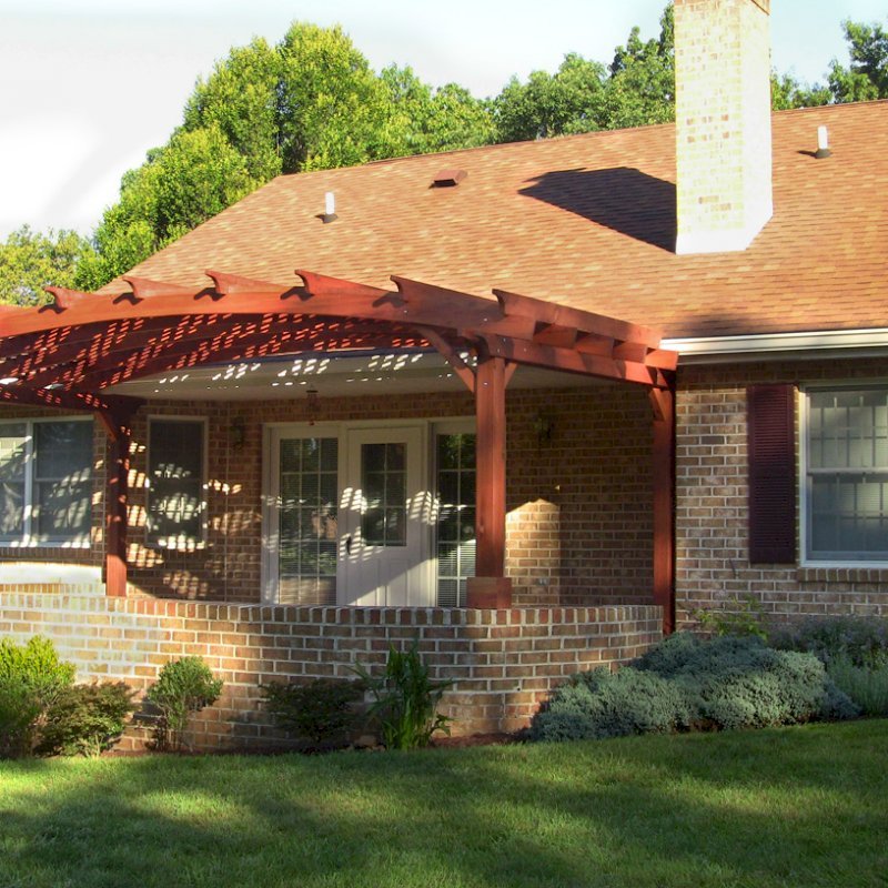 Arched Pergola Kits (Options: 10' L x 22' Arc W, Mature Redwood, Unattached, No Electrical Wiring Trim, Arched Roof with Lattice Panels, 4 Post Anchor kit for Stone, No Ceiling Fan Base, No Privacy Panels, No Curtain Rods, 9' Post Height (Front Posts Shorter by Custom Request), Cherry Stain Premium Sealant). Photo Courtesy of Josef M. of Fayetteville, Pennsylvania. Arched Pergola Kits (Options: 10' L x 22' Arc W, Mature Redwood, Unattached, No Electrical Wiring Trim, Arched Roof with Lattice Panels, 4 Post Anchor kit for Stone, No Ceiling Fan Base, No Privacy Panels, No Curtain Rods, 9' Post Height (Front Posts Shorter by Custom Request), Cherry Stain Premium Sealant). Photo Courtesy of Josef M. of Fayetteville, Pennsylvania.