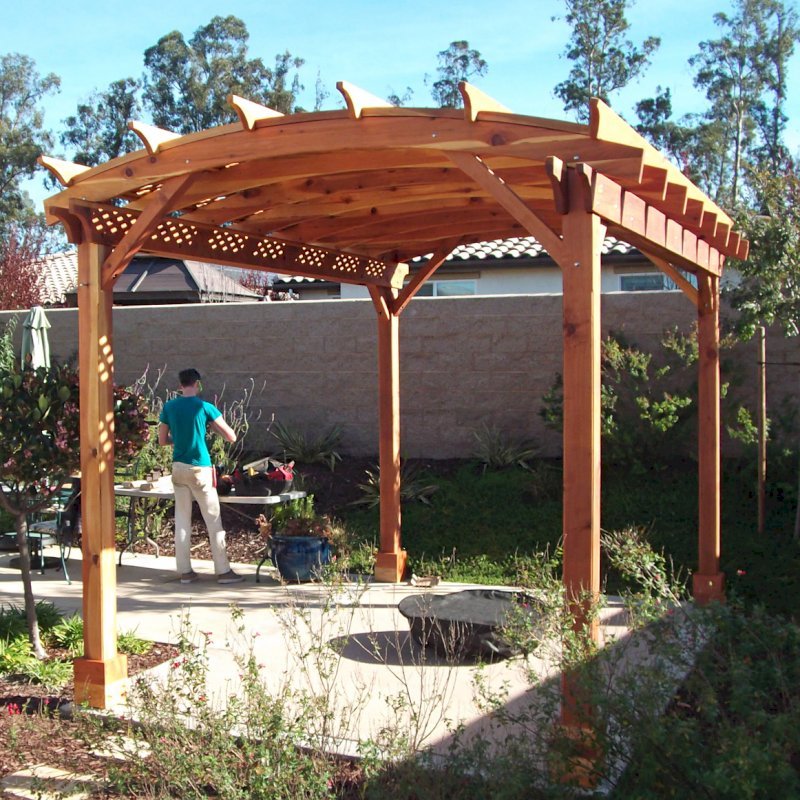 Arched Pergola Kit. (Options: 16' L x 12' Arc W, California Redwood, No Electrical Wiring Trims, Arched Roof with Lattice Panels, 4 Post Anchor Kit for Concrete, No Ceiling Fan Base, No Privacy Panels, No Curtain Rods, 6" Overhangs on Supports Side by Custom Request, Transparent Premium Sealant). Photo Courtesy of Fred Swendson. Arched Pergola Kit. (Options: 16' L x 12' Arc W, California Redwood, No Electrical Wiring Trims, Arched Roof with Lattice Panels, 4 Post Anchor Kit for Concrete, No Ceiling Fan Base, No Privacy Panels, No Curtain Rods, 6" Overhangs on Supports Side by Custom Request, Transparent Premium Sealant). Photo Courtesy of Fred Swendson.