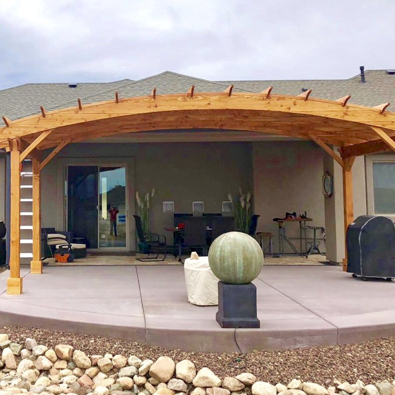 Arched Pergola Kit (Options: 10' L x 24' Arc W, Douglas-fir, No Electrical Wiring Trim, 4 Post Anchor Kit for Concrete, No Ceiling Fan Base, No Privacy Panels, No Curtain Rods, 9' Post Height, Transparent Premium Sealant). Photo Courtesy of H. Dolan of Prescott, AZ. Arched Pergola Kit (Options: 10' L x 24' Arc W, Douglas-fir, No Electrical Wiring Trim, 4 Post Anchor Kit for Concrete, No Ceiling Fan Base, No Privacy Panels, No Curtain Rods, 9' Post Height, Transparent Premium Sealant). Photo Courtesy of H. Dolan of Prescott, AZ.