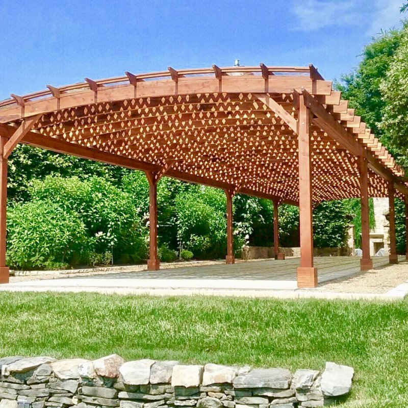 Arched Pergola Kit (Options: 74' L x 18.5' Arc W, Mature Redwood, Electrical Wiring Trim for 1 Post, 10 Post Anchor Kit for Concrete, 2 Ceiling Fan Bases, No Privacy Panels, No Curtain Rods, 9' Post Height, Transparent Premium Sealant). Acrylic Sheets Atop the Roof with Trims and Channels to Drain Water. Photo Courtesy of H. Mitchell of The Plains, VA. Arched Pergola Kit (Options: 74' L x 18.5' Arc W, Mature Redwood, Electrical Wiring Trim for 1 Post, 10 Post Anchor Kit for Concrete, 2 Ceiling Fan Bases, No Privacy Panels, No Curtain Rods, 9' Post Height, Transparent Premium Sealant). Acrylic Sheets Atop the Roof with Trims and Channels to Drain Water. Photo Courtesy of H. Mitchell of The Plains, VA.