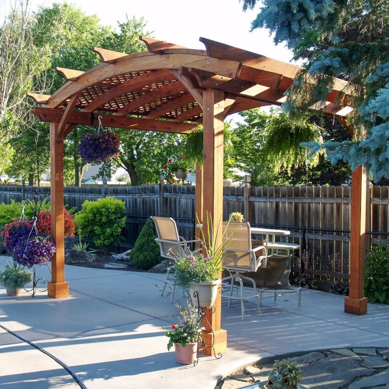 Arched Pergola Kits (Options: 12' L x 12' Arc W, Mature Redwood, Unattached, No Electrical Wiring Trim, Arched Roof with Lattice Panels, 4 Post Anchor Kit for Stone, No Ceiling Fan Base, No Privacy Panels, No Curtain Rods, 9' Post Height, Transparent Premium Sealant). Photo Courtesy of Jim Beatty of North Tonawanda, NY. Arched Pergola Kits (Options: 12' L x 12' Arc W, Mature Redwood, Unattached, No Electrical Wiring Trim, Arched Roof with Lattice Panels, 4 Post Anchor Kit for Stone, No Ceiling Fan Base, No Privacy Panels, No Curtain Rods, 9' Post Height, Transparent Premium Sealant). Photo Courtesy of Jim Beatty of North Tonawanda, NY.