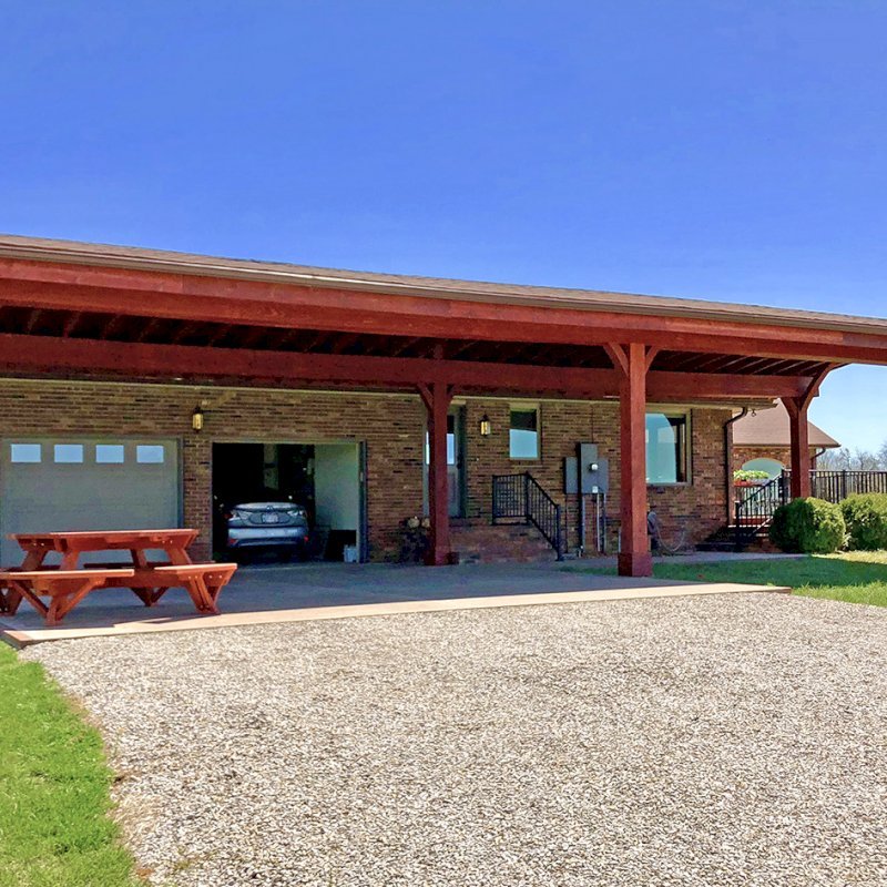 Custom Arched Thick Timber Pavilion (Options: 55' L x 22' Arc W, California Redwood, No Electrical Wiring Trim, 6 Post Anchor Kit for Gale-Wind, 2 Ceiling Fan Bases, No Privacy Panel, No Curtain Rods, 10ft H, Cherry Stain Premium Sealant) Support timbers covered by custom request. Photo also shows a Round Picnic Table. Photo Courtesy of J. Hartmann of Pittsburg, KS. Custom Arched Thick Timber Pavilion (Options: 55' L x 22' Arc W, California Redwood, No Electrical Wiring Trim, 6 Post Anchor Kit for Gale-Wind, 2 Ceiling Fan Bases, No Privacy Panel, No Curtain Rods, 10ft H, Cherry Stain Premium Sealant) Support timbers covered by custom request. Photo also shows a Round Picnic Table. Photo Courtesy of J. Hartmann of Pittsburg, KS.