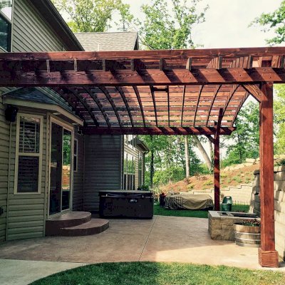 Attached Arched Pergola Kits (Options: 20' L x 26' W, Douglas-fir, No Electrical Wiring Trim, Rafters at 18" and Slats at 18", Widthwise Roof Support Timbers, 2-Post Anchor Kit for Concrete, Ceiling Fan Base, No Privacy Panels, No Curtain Rods, 11' Post Height, Coffee-Stain Premium Sealant). Photo Courtesy of Susanne Stephens of Eureka, Missouri.