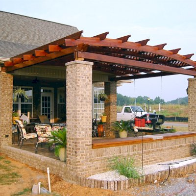 Attached Arched Pergola Kits (Options: 14' L x 18' W, California Redwood, No Electrical Wiring Trim, Arched Roof with Lattice Panels, 2-Post Anchor Kit for Concrete, No Ceiling Fan Base, No Privacy Panels, No Curtain Rods, 9' Post Height,  Transparent Premium Sealant).  Posts wrapped in masonry. Photo courtesy of Mr. Brandon Campbell of  Lenoir City, Tennessee. 