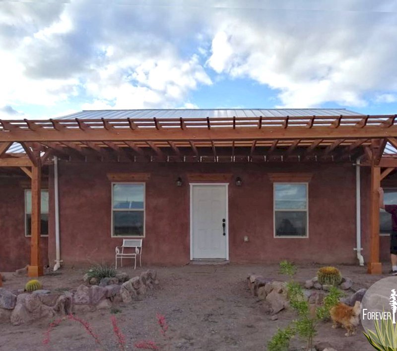 Attached Garden Pergolas (Options: 25' L x 12' W & 25' L x 7' W , Attached to Wall by Support Side, Douglas-fir, No Electrical Wiring Trim, Post Anchor Kit for Gale-Wind, Open Roof with Slats at 18", Rafters at 18", No Post Decorative Trims, Transparent Premium Sealant). Photo Courtesy of N. Miller of Las Cruces, New Mexico. Attached Garden Pergolas (Options: 25' L x 12' W & 25' L x 7' W , Attached to Wall by Support Side, Douglas-fir, No Electrical Wiring Trim, Post Anchor Kit for Gale-Wind, Open Roof with Slats at 18", Rafters at 18", No Post Decorative Trims, Transparent Premium Sealant). Photo Courtesy of N. Miller of Las Cruces, New Mexico.