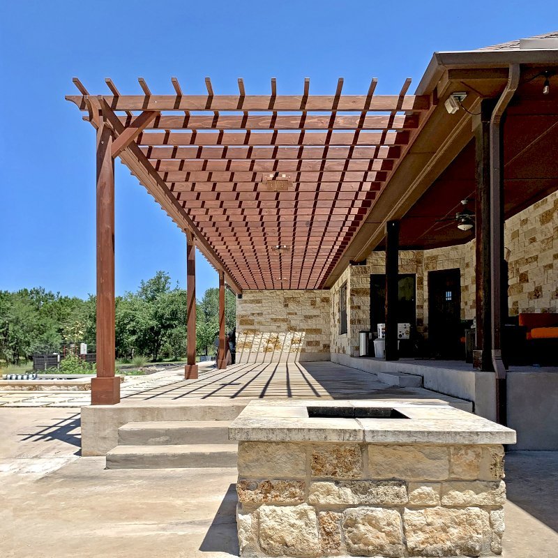 Custom Attached Garden Pergola (Options: 53' x 12', California Redwood, Open Roof with Slats at 12", Rafters at 18", 3-Post Anchor Kit for Concrete, 3 Ceiling Fan Bases, Coffee-Stain Premium Sealant). Ledger Board Attached to Wood House Fascia on 53' Side, and Steel Plate Used to Attach Dual Supports to Masonry House Wall. Photo Courtesy of S. Slawson of Buda, Texas. Custom Attached Garden Pergola (Options: 53' x 12', California Redwood, Open Roof with Slats at 12", Rafters at 18", 3-Post Anchor Kit for Concrete, 3 Ceiling Fan Bases, Coffee-Stain Premium Sealant). Ledger Board Attached to Wood House Fascia on 53' Side, and Steel Plate Used to Attach Dual Supports to Masonry House Wall. Photo Courtesy of S. Slawson of Buda, Texas.