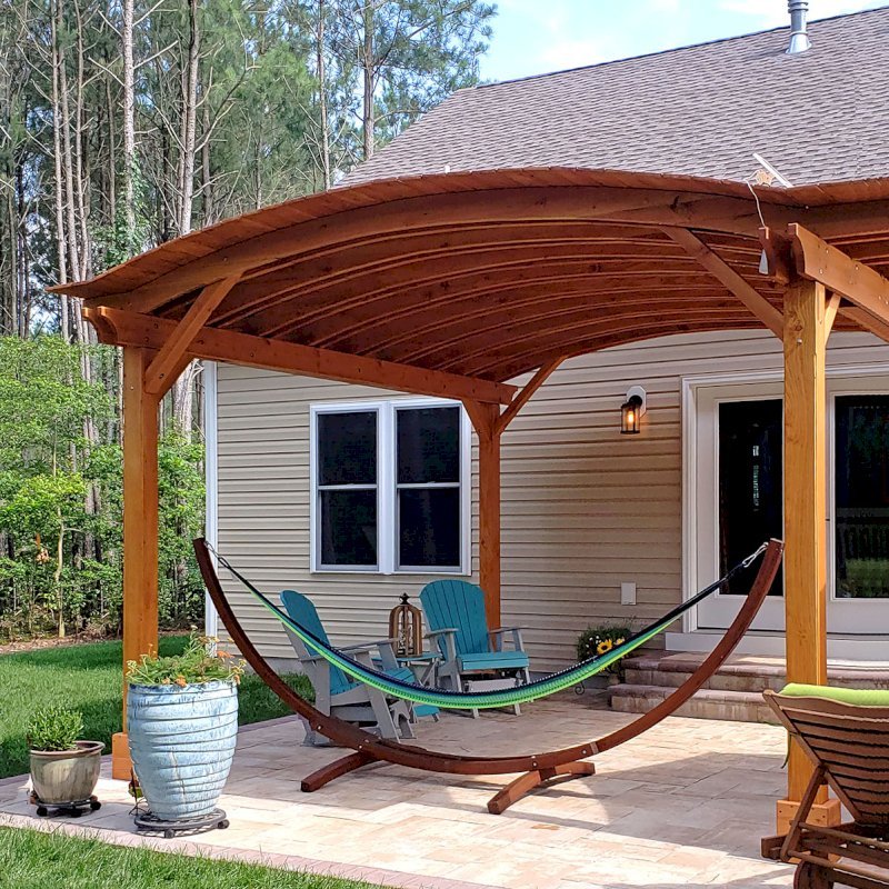 Backyard Pavilion Kits (Options: 16' L x 15' Arc W, Douglas-fir, No Post Electrical Wiring Trim, 4 Post Anchor Kit for Concrete, No Ceiling Fan Base, No Privacy Panels, No Curtain Rods, 9 ft Post Height, Transparent Premium Sealant). Photo Courtesy of S. Fly of Millsboro, Delaware. Backyard Pavilion Kits (Options: 16' L x 15' Arc W, Douglas-fir, No Post Electrical Wiring Trim, 4 Post Anchor Kit for Concrete, No Ceiling Fan Base, No Privacy Panels, No Curtain Rods, 9 ft Post Height, Transparent Premium Sealant). Photo Courtesy of S. Fly of Millsboro, Delaware.