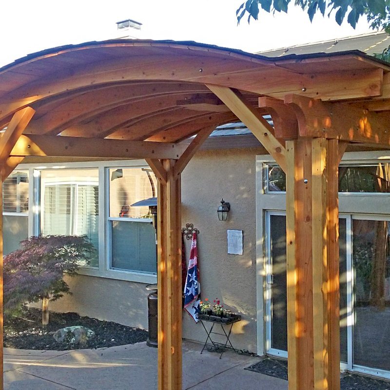 Backyard Pavilion Kits (Options: 12' L x 10' Arc W, Douglas-fir, 1 Post Electrical Wiring Trim, 4 Post Anchor Kit for Concrete, Add Ceiling Fan Base, No Privacy Panels, No Curtain Rods, 9 ft Post Height, Transparent Premium Sealant). Photo Courtesy of R. Short of Roseville, CA. Backyard Pavilion Kits (Options: 12' L x 10' Arc W, Douglas-fir, 1 Post Electrical Wiring Trim, 4 Post Anchor Kit for Concrete, Add Ceiling Fan Base, No Privacy Panels, No Curtain Rods, 9 ft Post Height, Transparent Premium Sealant). Photo Courtesy of R. Short of Roseville, CA.