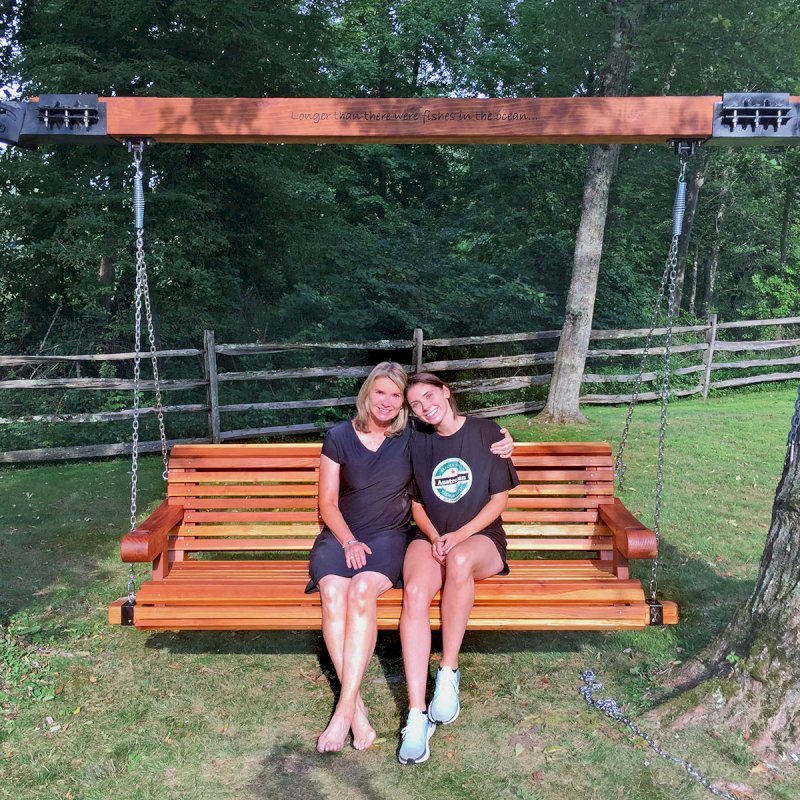 Bench Swings (Seats Only) (Options: XL Garden Bench, California Redwood, Ensenada Seat Design, Custom Engraving, Custom Heavy Duty Hinged Steel Harnesses with a 6x6 Beam, Transparent Premium Sealant). Custom Tree Rings and Beam Designed by Forever Redwood to Attach Swing to the 2 Trees. Photo Courtesy of P. Scaturro of Bedford, New York. Bench Swings (Seats Only) (Options: XL Garden Bench, California Redwood, Ensenada Seat Design, Custom Engraving, Custom Heavy Duty Hinged Steel Harnesses with a 6x6 Beam, Transparent Premium Sealant). Custom Tree Rings and Beam Designed by Forever Redwood to Attach Swing to the 2 Trees. Photo Courtesy of P. Scaturro of Bedford, New York.