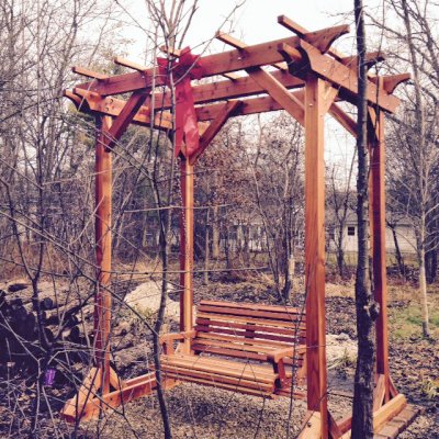 Bench Swings (Seats Only) (Options: Standard Garden Bench, California Redwood, Ensenada Design Seat, No Engraving, All Beam Hanging Hardware, Transparent Premium Sealant) with a Small Pergola. Photo Courtesy of Howard Heidlauf of St. Charles, Illinois.