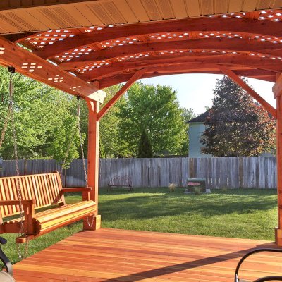 Bench Swings (Seats Only) (Options: Standard Garden Bench, California Redwood, Classic Seat Design, No Engraving, All Beam Hanging Hardware, Transparent Premium Sealant). Photo also shows a custom deck and an attached garden pergola. Photo courtesy of Telory A. of Springfield, MO.