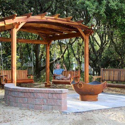 Bench Swings (Seats Only) (Options: Large Garden Bench, California Redwood, Classic Design Seat, No Engraving, All Beam Hanging Hardware, Transparent Premium Sealant). Photo Also Shows an Arched Pergola and a Ti Amo Bench. Photo Courtesy of Tom Marten of Kitty Hawk, NC.