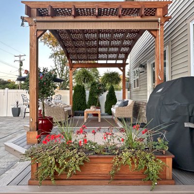Carmel Box Planter (Options: 60" L, 12" W, 12" H, Douglas-fir, Standard Base, No Steel Hangers, No fit over railings, Interior and Exterior of Box with Sealant (No Growing Vegetables), Transparent Premium Sealant). Photo Also Shows an Arched Pergola. Photo Taken 1 Year After Installation. Photo Courtesy of S. Bono of Royal Oak, MI.