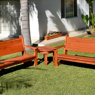 Carmel Box Planters in Background (Options: 60" L, 10.5" W, 7.5" H, California Redwood, Standard Base, No Steel Hangers, No fit over railings, Interior and Exterior of Box with Sealant (No Growing Vegetables), Transparent Premium Sealant). In front of planter are 2 Angel Benches with a Round Side Table. 