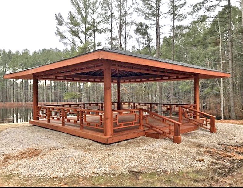 Custom Wood Pavilion Kits (Options: 32' L x 32' W, Mature Redwood, Electrical Wiring Trim Kit for 2 Posts, Hurricane-Wind Anchors, 4' Overhang, 11 1/4" Diam. Posts, Transparent Premium Sealant, with Custom Deck and Rails). Photo Courtesy of J. Hill of Apex, North Carolina. Custom Wood Pavilion Kits (Options: 32' L x 32' W, Mature Redwood, Electrical Wiring Trim Kit for 2 Posts, Hurricane-Wind Anchors, 4' Overhang, 11 1/4" Diam. Posts, Transparent Premium Sealant, with Custom Deck and Rails). Photo Courtesy of J. Hill of Apex, North Carolina.