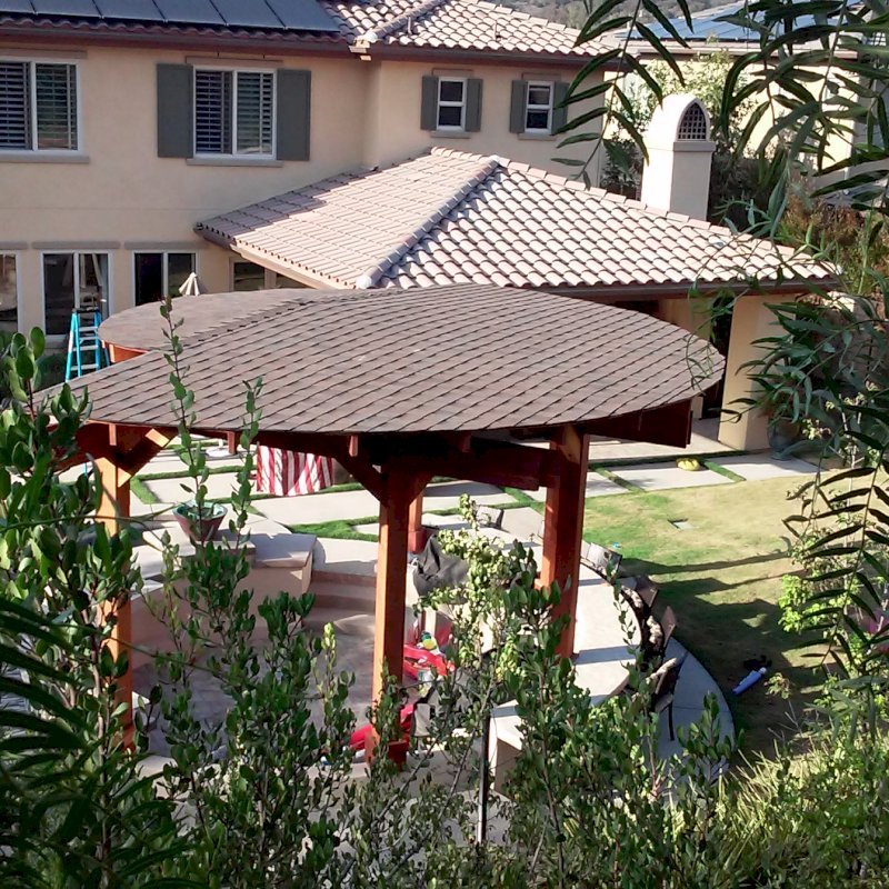 Custom Wood Pavilion Kits (Options: 24' Diameter. Post 9'-3/4", Arch Supports, 6 grades Slope Roof, California Redwood, Unattached, Electrical Wiring Trim for 1 Post, 6-post kit for stone, brick, or concrete (with anchor bolts), No Ceiling Fan Base, No Privacy Panels, No Curtain Rods, 10' Post Height, Transparent Premium Sealant) Custom Wood Pavilion Kits (Options: 24' Diameter. Post 9'-3/4", Arch Supports, 6 grades Slope Roof, California Redwood, Unattached, Electrical Wiring Trim for 1 Post, 6-post kit for stone, brick, or concrete (with anchor bolts), No Ceiling Fan Base, No Privacy Panels, No Curtain Rods, 10' Post Height, Transparent Premium Sealant)