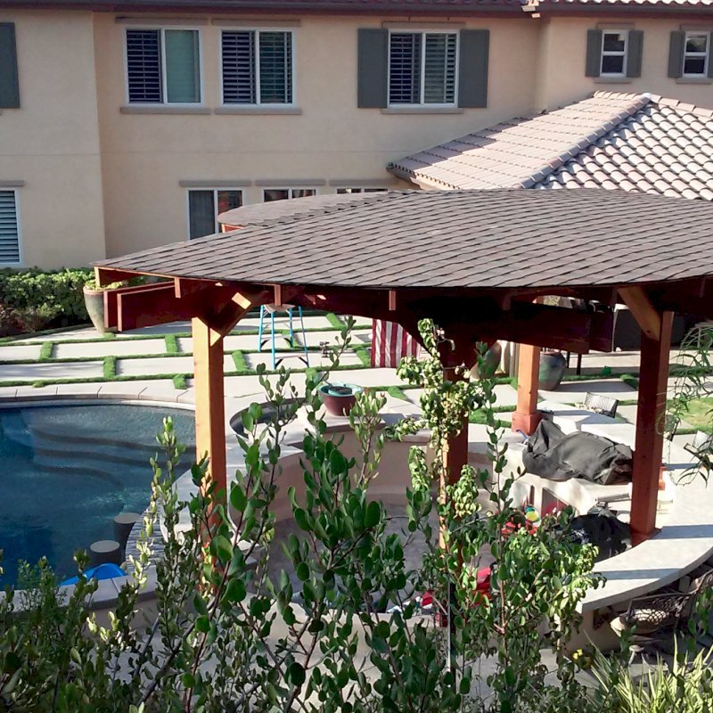 Custom Wood Pavilion Kits (Options: 24' Diameter. Post 9'-3/4", Arch Supports, 6 Grades Slope Roof, California Redwood, Unattached, Electrical Wiring Trim for 1 Post, 6-post kit for stone, brick, or concrete (with anchor bolts), No Ceiling Fan Base, No Privacy Panels, No Curtain Rods, 10' Post Height, Transparent Premium Sealant) Custom Wood Pavilion Kits (Options: 24' Diameter. Post 9'-3/4", Arch Supports, 6 Grades Slope Roof, California Redwood, Unattached, Electrical Wiring Trim for 1 Post, 6-post kit for stone, brick, or concrete (with anchor bolts), No Ceiling Fan Base, No Privacy Panels, No Curtain Rods, 10' Post Height, Transparent Premium Sealant)