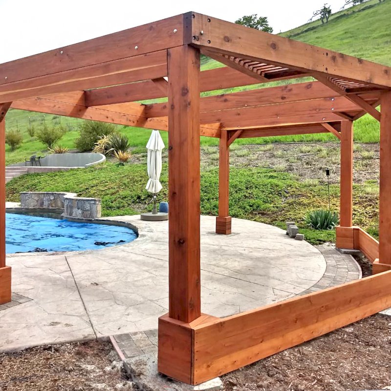 Custom Wooden Pergola (Options: 20' x 12', Mature Redwood, Posts Anchor Kit for High-Wind, Transparent Premium Sealant). Photo Courtesy of D. Ruprecht of Hollister, CA. Custom Wooden Pergola (Options: 20' x 12', Mature Redwood, Posts Anchor Kit for High-Wind, Transparent Premium Sealant). Photo Courtesy of D. Ruprecht of Hollister, CA.