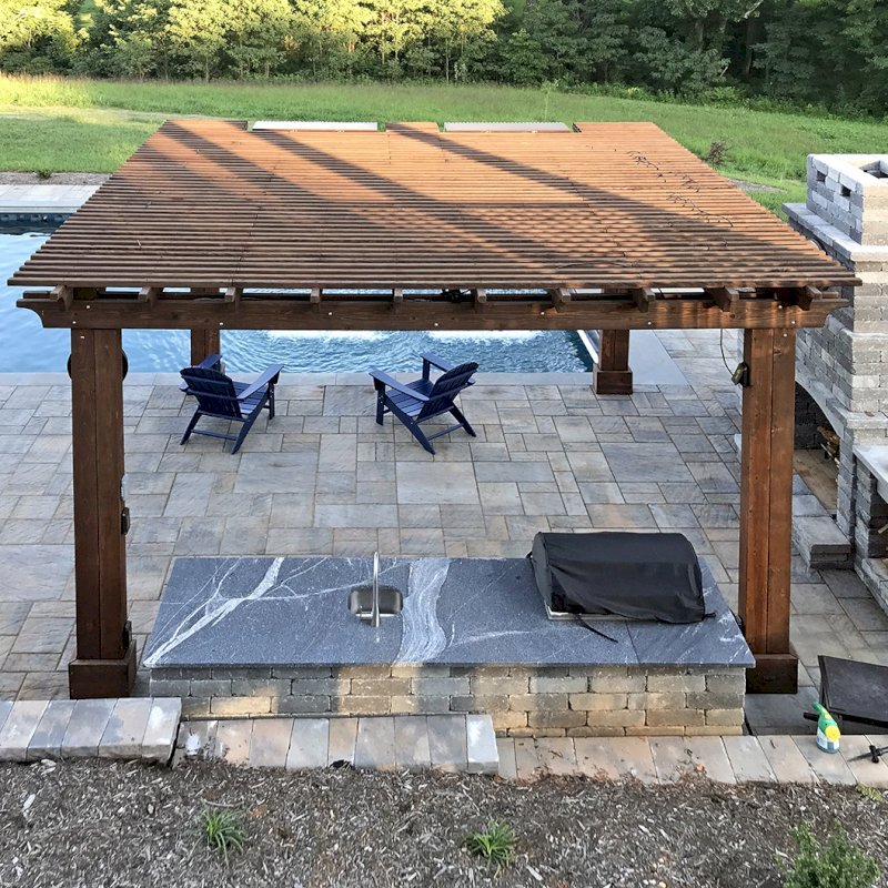 Custom Garden Pergola (Options: 16' L x 16' W, California Redwood, 4-Post Anchor Kit for Concrete, Cherry Stain Premium Sealant). Plumbing was built into the timbers to create a waterfall. Photo Courtesy of D. Hogan of Charlottesville, Virginia. Custom Garden Pergola (Options: 16' L x 16' W, California Redwood, 4-Post Anchor Kit for Concrete, Cherry Stain Premium Sealant). Plumbing was built into the timbers to create a waterfall. Photo Courtesy of D. Hogan of Charlottesville, Virginia.