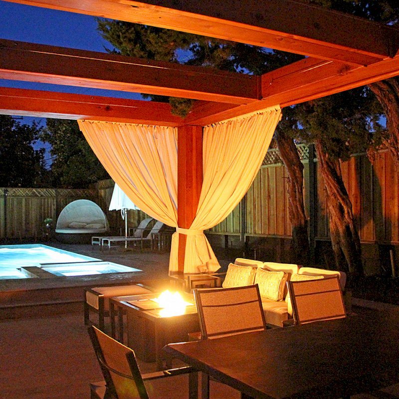 Custom Wooden Fat Timber Pergola (Options: 20' L, 16' W, Old-Growth Redwood, 4 Electrical Wiring Trims, with 2 3/4" x 11 1/4" Roof Timbers and 11 1/4" x 11 1/4" Posts, 4-Post Anchor Kit for High-Wind, No Privacy Panels, Curtain Rods on 4 sides, 10' Post Height, Transparent Premium Sealant). Retractable Canopy designed in cooperation with Infinity Canopy of Los Angeles, CA (www.infinitycanopy.com). Once you have your design finalized, you can forward your drawings to Infinity to add the perfect retractable canopy solution for maximum shade versatility! Photo Courtesy of Darren & Elva Linscott of San Jose, CA. Custom Wooden Fat Timber Pergola (Options: 20' L, 16' W, Old-Growth Redwood, 4 Electrical Wiring Trims, with 2 3/4" x 11 1/4" Roof Timbers and 11 1/4" x 11 1/4" Posts, 4-Post Anchor Kit for High-Wind, No Privacy Panels, Curtain Rods on 4 sides, 10' Post Height, Transparent Premium Sealant). Retractable Canopy designed in cooperation with Infinity Canopy of Los Angeles, CA (www.infinitycanopy.com). Once you have your design finalized, you can forward your drawings to Infinity to add the perfect retractable canopy solution for maximum shade versatility! Photo Courtesy of Darren & Elva Linscott of San Jose, CA.