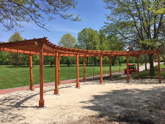 Custom Fan Shaped Corner Pergola (Options: 50' x 12', California Redwood, Open Roof with Slats at 18", No Electrical Wiring Trim Kit, 12-Post Anchor Kit for Concrete, No Ceiling Fan Base, 9' Posts, No Curtain Rods, Transparent Premium Sealant). Photo Courtesy of A. Amstutz of Toledo, OH. Custom Fan Shaped Corner Pergola (Options: 50' x 12', California Redwood, Open Roof with Slats at 18", No Electrical Wiring Trim Kit, 12-Post Anchor Kit for Concrete, No Ceiling Fan Base, 9' Posts, No Curtain Rods, Transparent Premium Sealant). Photo Courtesy of A. Amstutz of Toledo, OH.