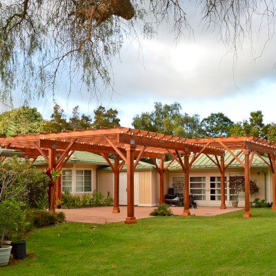 Custom Wooden Pergola (Options: 39' x 50', Mature Redwood, 3 1/8" x 15" Glulam Beams/Supports, 3 3/4" x 7 1/4" Rafters and 1 3/4" x 3 3/4" Slats, Double 5 /12" x 5 1/2" x 10' Posts, Custom Post Anchors, Transparent Premium Sealant). Photo Courtesy of D. Cole of Maui, Hawaii.