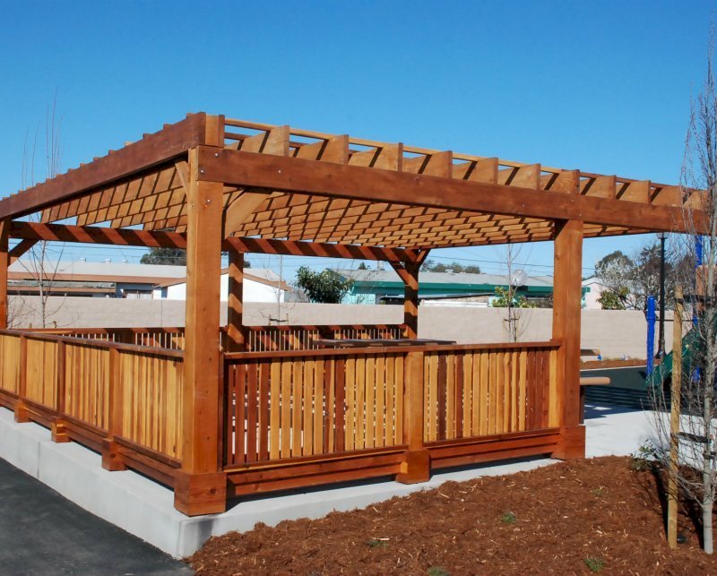 Custom Wooden Pergola (Options: 24' x 24', California Redwood, Open Roof with Slats at 18", Rafters at 18", 1¾" x 9¼" Supports and Rafters, 8 x 8 Posts, Transparent Premium Sealant). Photo Courtesy of Wanlass Park of San Pablo, CA. Custom Wooden Pergola (Options: 24' x 24', California Redwood, Open Roof with Slats at 18", Rafters at 18", 1¾" x 9¼" Supports and Rafters, 8 x 8 Posts, Transparent Premium Sealant). Photo Courtesy of Wanlass Park of San Pablo, CA.